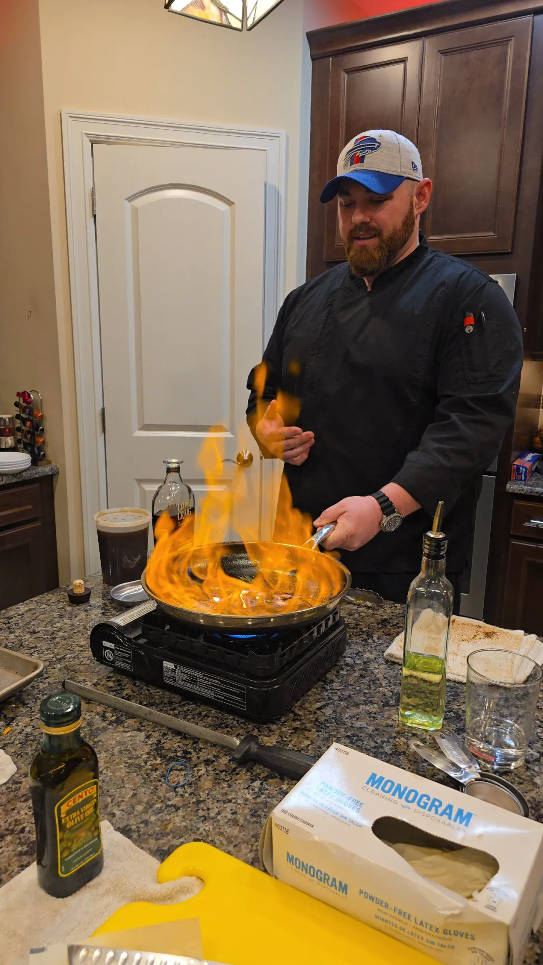 Chef Michael at the stove as a pan flares up into flame