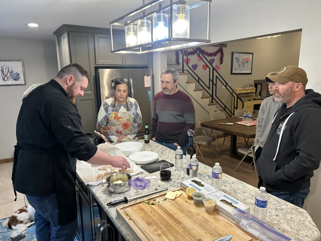 Chef Michael with a small group around the kitchen counter